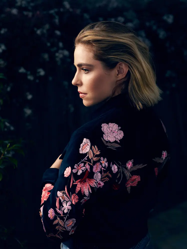 Fashion portrait of a woman in a dark floral dress