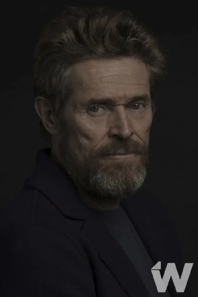 Low-key editorial portrait of Willem Dafoe