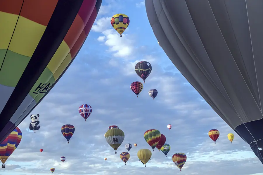 Hot-air balloons filling a bright blue New Mexico sky