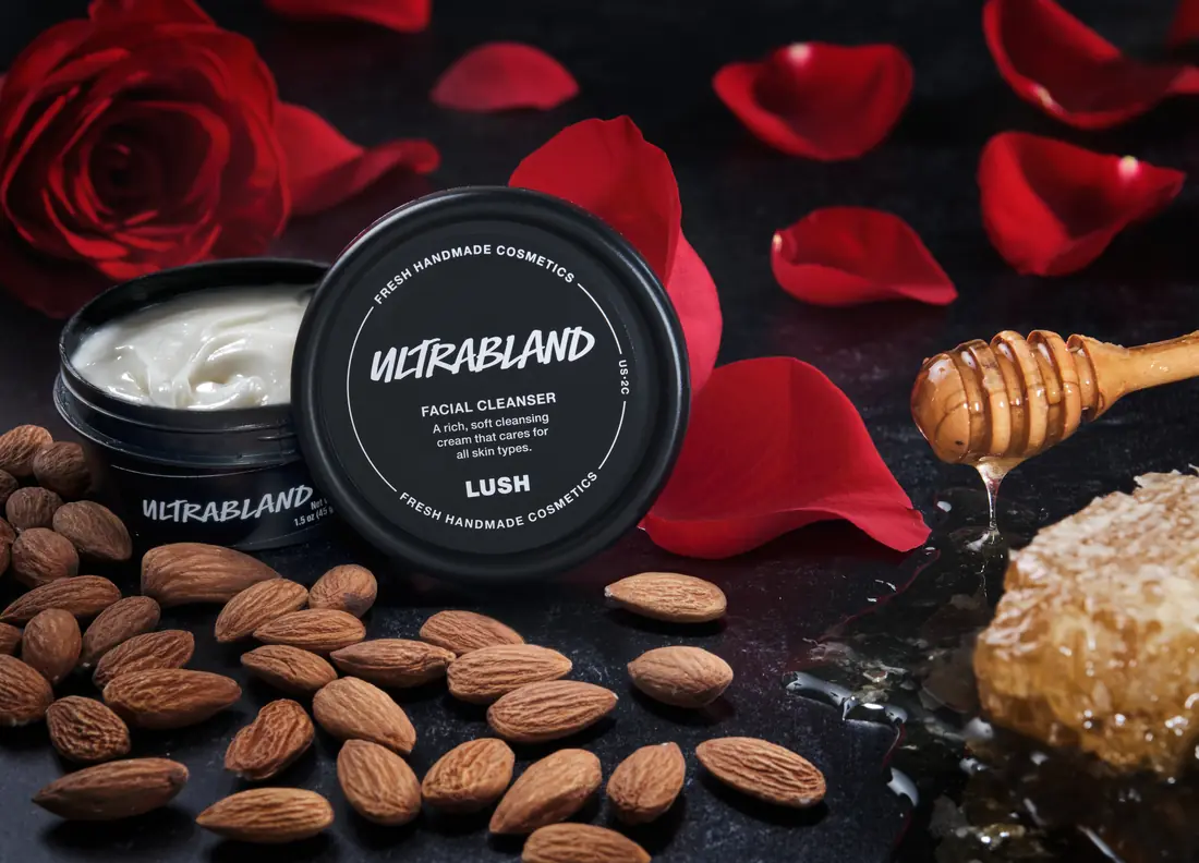 Lush Ultrabland skincare among almonds, honey, and red rose petals
