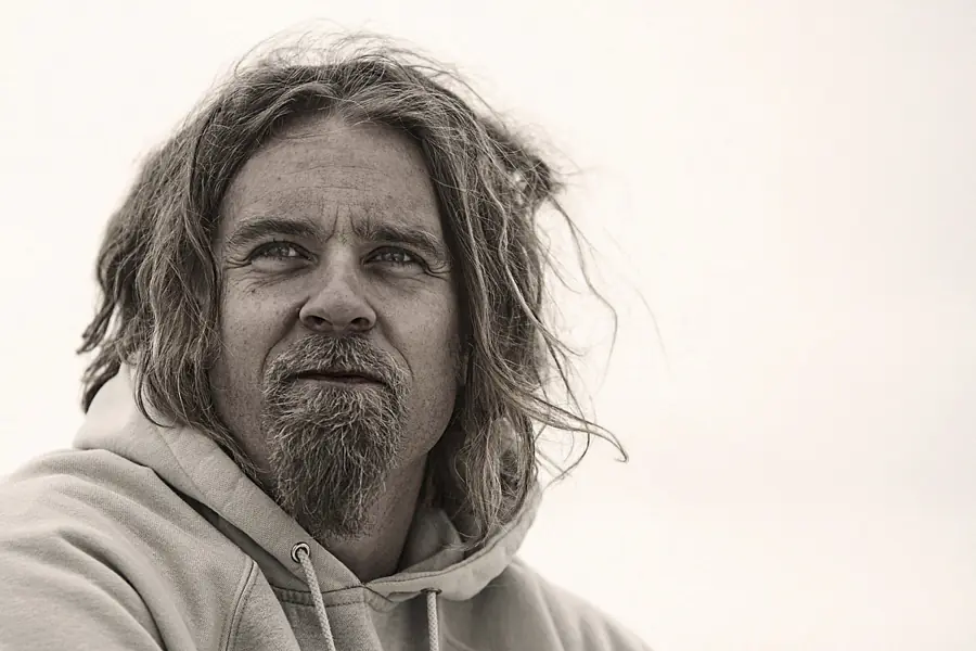 Black-and-white environmental portrait of a man